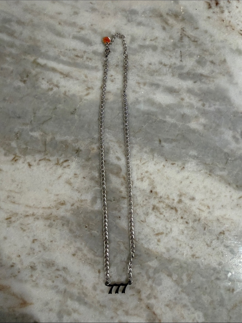 Silver Chain Necklace with Black '777' Pendant and Orange Accent